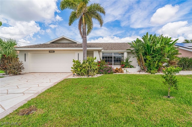 single story home with concrete driveway, a front yard, an attached garage, and stucco siding