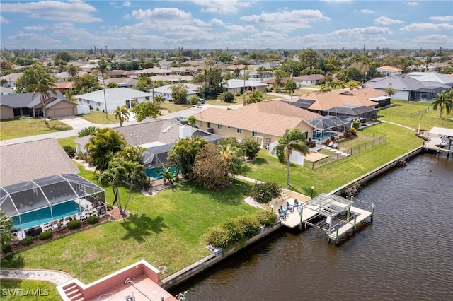 birds eye view of property with a residential view and a water view