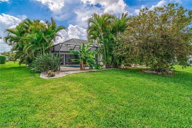 view of yard featuring glass enclosure