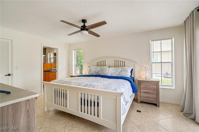 bedroom featuring light tile patterned floors, ceiling fan, and multiple windows