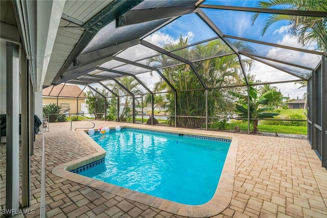 outdoor pool with a patio and glass enclosure