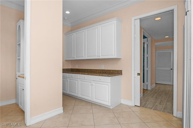 interior space with light tile patterned floors, baseboards, crown molding, and recessed lighting