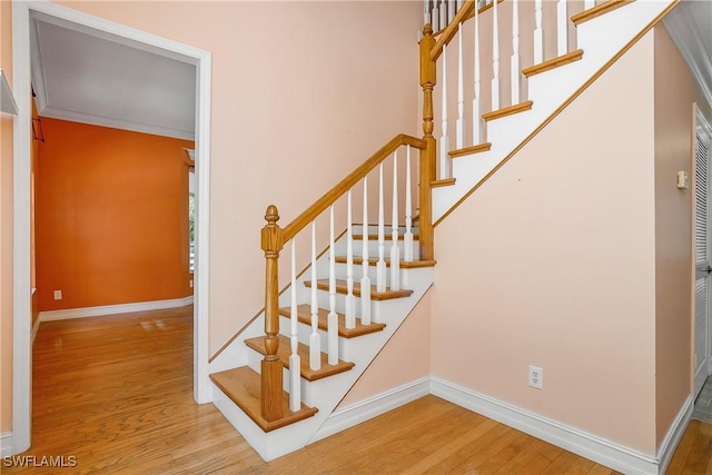 staircase with wood finished floors and baseboards