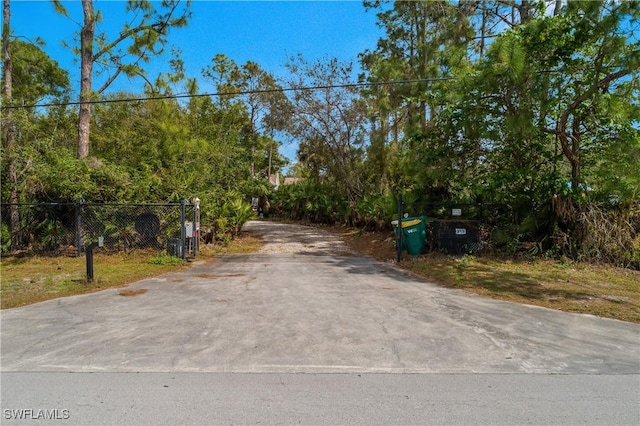 view of street featuring concrete driveway