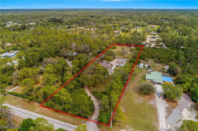 birds eye view of property with a view of trees