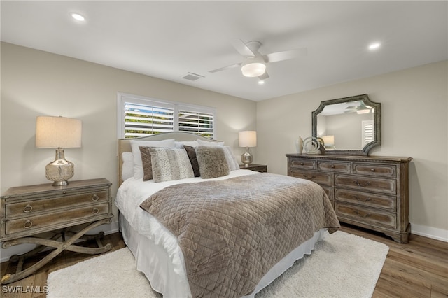 bedroom with recessed lighting, wood finished floors, a ceiling fan, baseboards, and visible vents