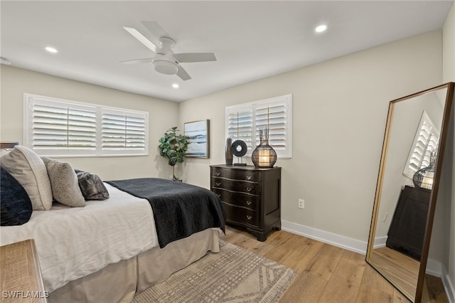 bedroom with light wood-style floors, baseboards, and recessed lighting