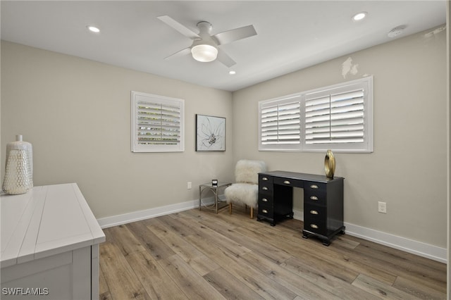 office space with recessed lighting, light wood-style flooring, and baseboards