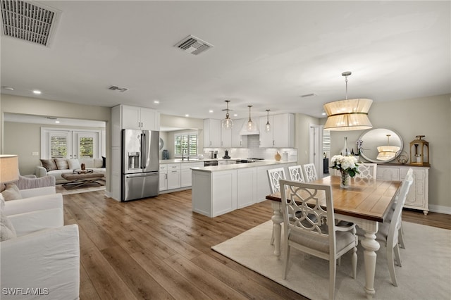 dining space featuring recessed lighting, visible vents, and light wood finished floors