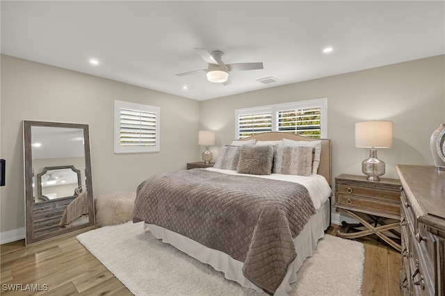 bedroom with visible vents, baseboards, ceiling fan, light wood-type flooring, and recessed lighting