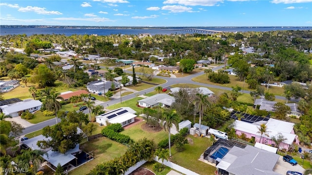 drone / aerial view with a water view and a residential view