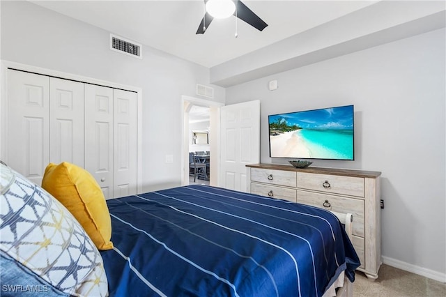 carpeted bedroom featuring a ceiling fan, baseboards, visible vents, and a closet