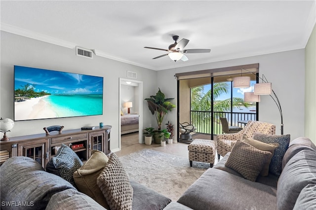 living room with a ceiling fan, visible vents, crown molding, and light tile patterned floors