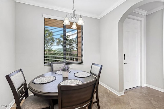 dining room featuring baseboards, arched walkways, a notable chandelier, and ornamental molding