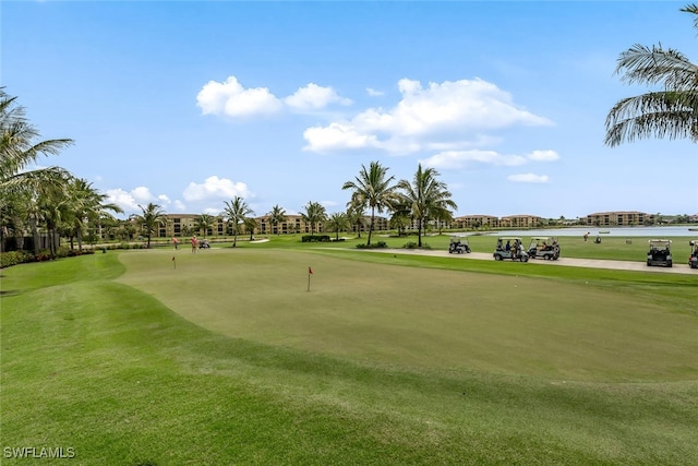 view of property's community featuring golf course view and a lawn