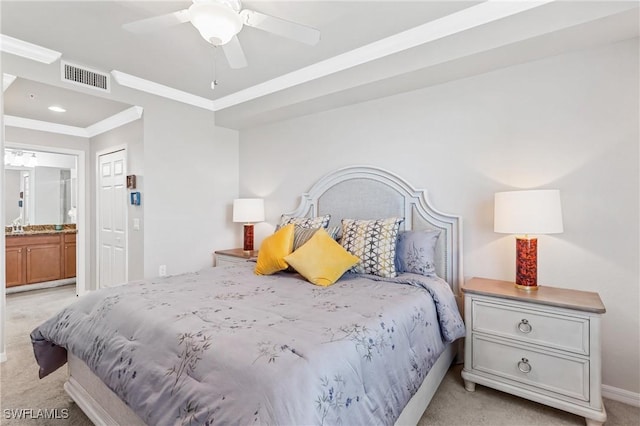 bedroom featuring light colored carpet, a ceiling fan, visible vents, ornamental molding, and ensuite bath