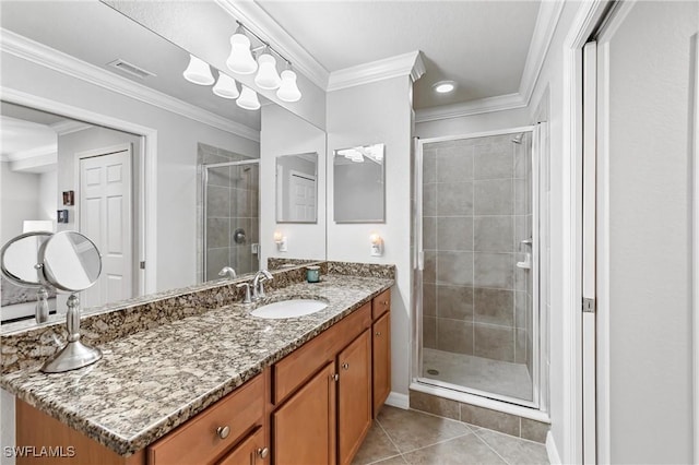 full bathroom featuring ornamental molding, a stall shower, and vanity