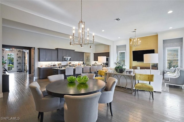 dining area featuring dark wood-type flooring, recessed lighting, a chandelier, and visible vents