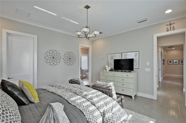 bedroom featuring baseboards, visible vents, wood finished floors, crown molding, and a chandelier