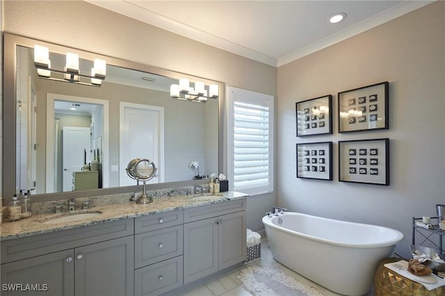 bathroom with ornamental molding, a soaking tub, a sink, and double vanity