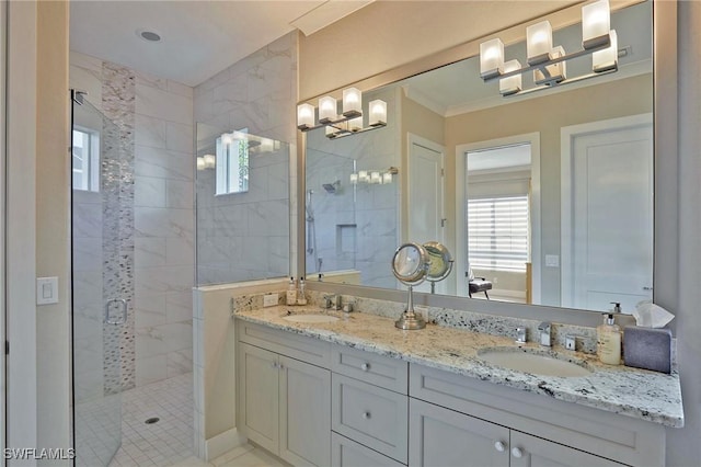 bathroom featuring ornamental molding, a stall shower, a sink, and double vanity