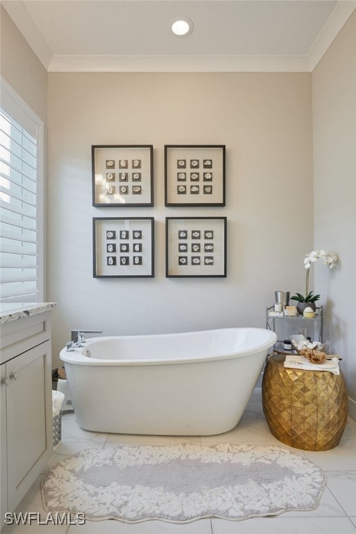 full bathroom featuring ornamental molding, marble finish floor, and a freestanding tub