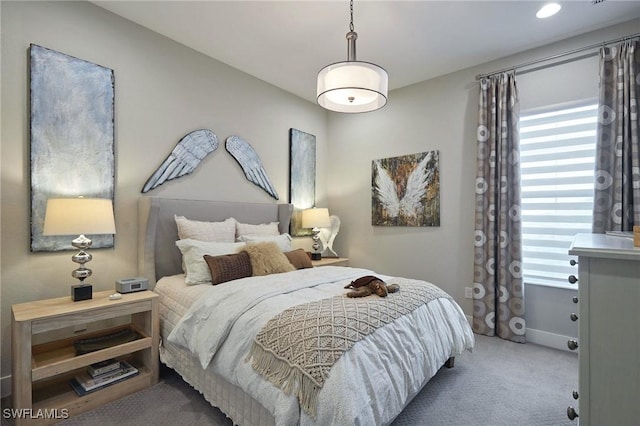 bedroom featuring multiple windows and carpet