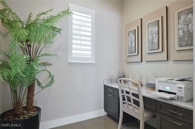 office space featuring baseboards and wood finished floors