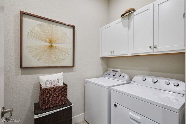 clothes washing area featuring cabinet space and separate washer and dryer