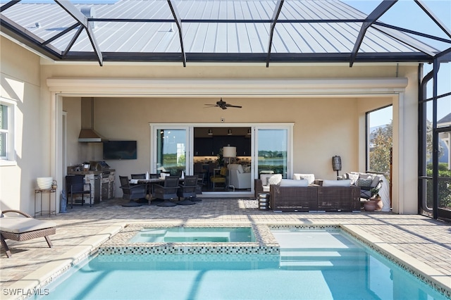 back of house featuring a standing seam roof, a patio area, an outdoor living space, and stucco siding