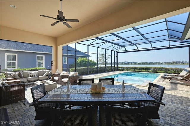 outdoor pool with a ceiling fan, a lanai, a patio area, and an outdoor hangout area