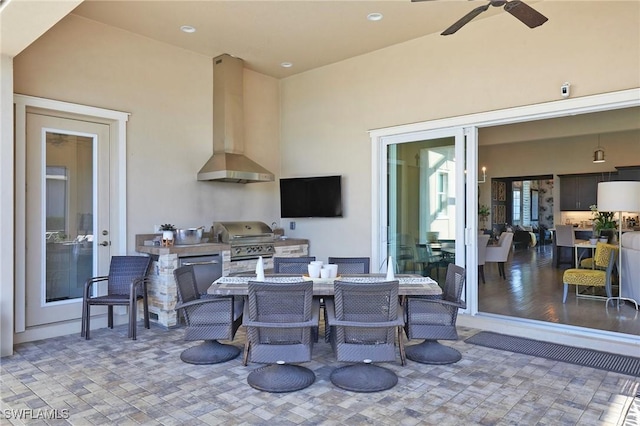 view of patio / terrace with outdoor dining space, area for grilling, a grill, and a ceiling fan