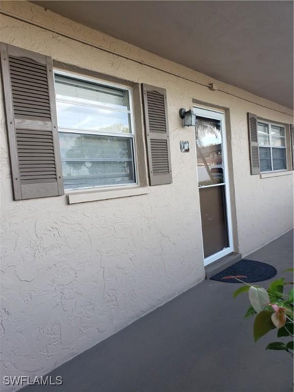 view of exterior entry with stucco siding