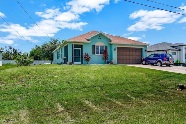 view of front of house with driveway, stucco siding, an attached garage, fence, and a front yard