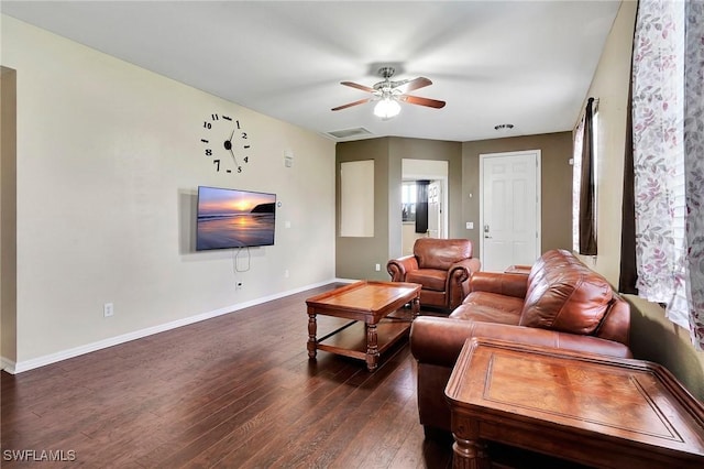 living room with a ceiling fan, dark wood finished floors, visible vents, and baseboards