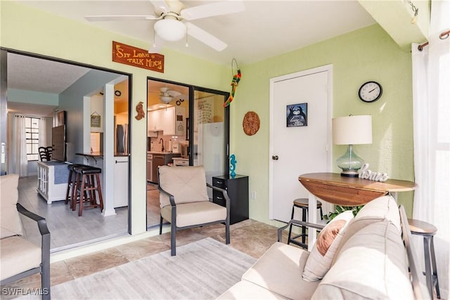 living area with a ceiling fan