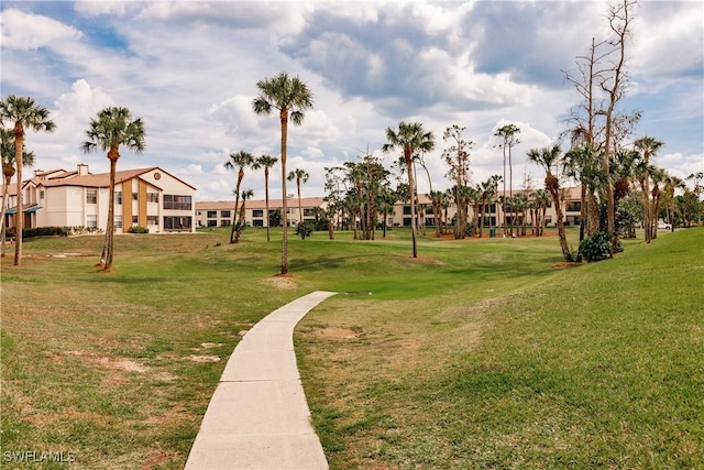 view of property's community with a lawn