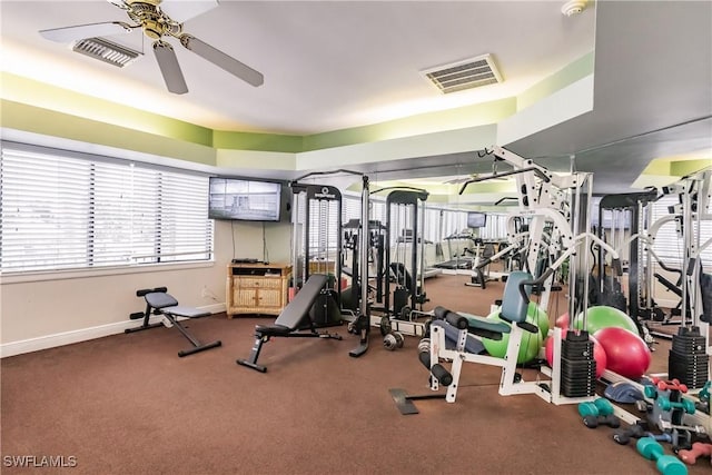 workout area with baseboards, visible vents, and a ceiling fan