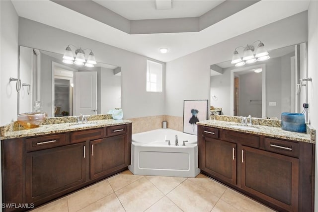 full bathroom featuring a sink, a garden tub, tile patterned flooring, and two vanities