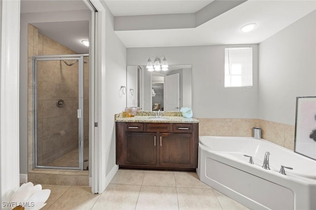 full bath with a garden tub, a stall shower, tile patterned flooring, and vanity