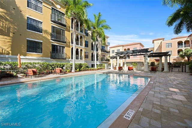 pool featuring fence and a patio