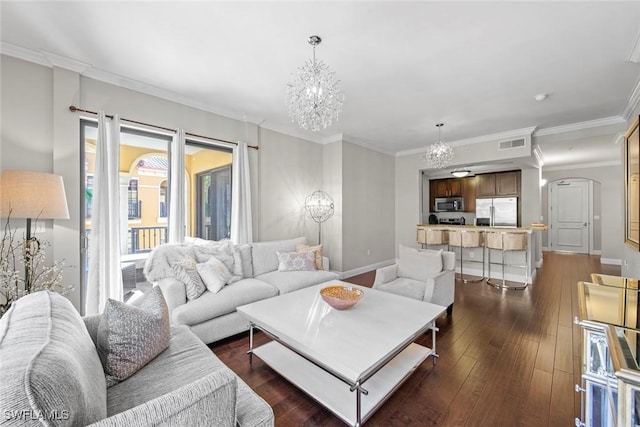 living room featuring baseboards, visible vents, arched walkways, dark wood-style floors, and an inviting chandelier