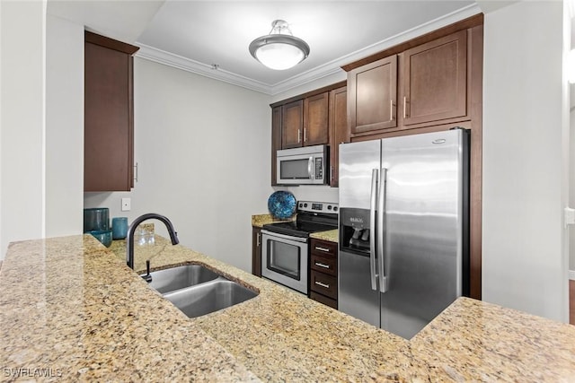 kitchen with light stone countertops, appliances with stainless steel finishes, a sink, and ornamental molding