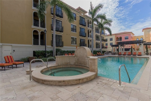 community pool with a community hot tub and a patio