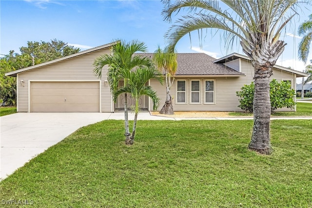 view of front of house featuring a garage, driveway, a shingled roof, and a front yard