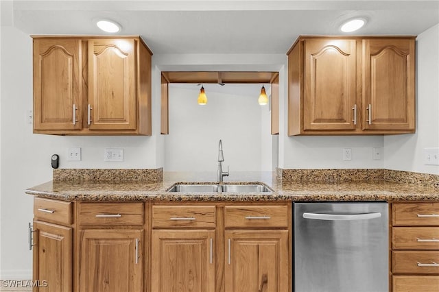 kitchen featuring dark stone countertops, brown cabinetry, a sink, and stainless steel dishwasher