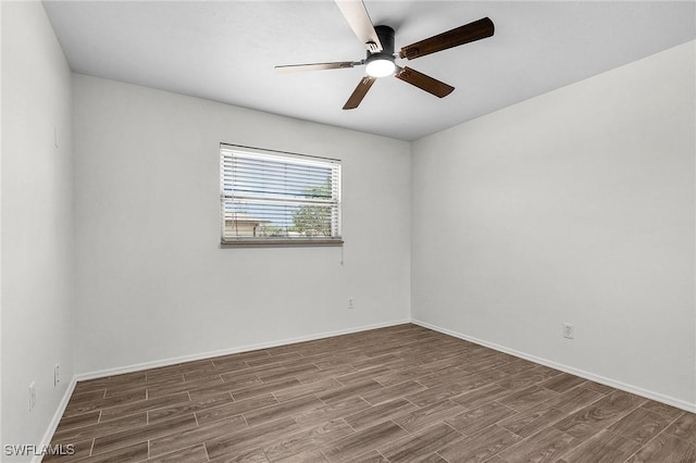 empty room featuring ceiling fan, baseboards, and wood finished floors