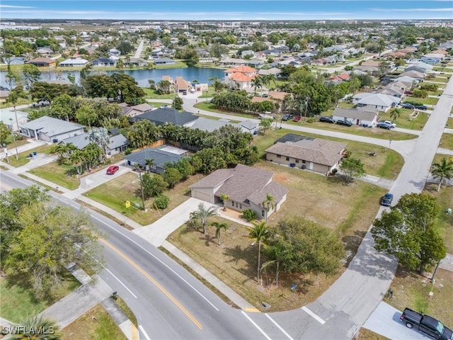 bird's eye view featuring a water view and a residential view