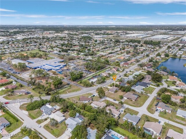 birds eye view of property with a residential view and a water view