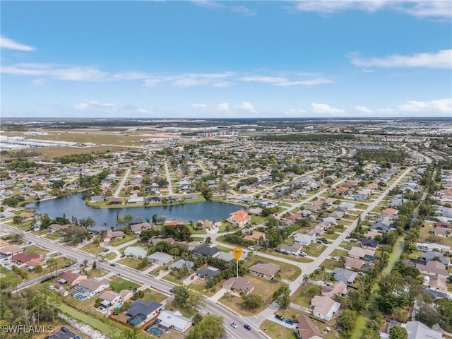 birds eye view of property featuring a water view and a residential view